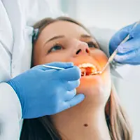 Performing dental cleaning on patient